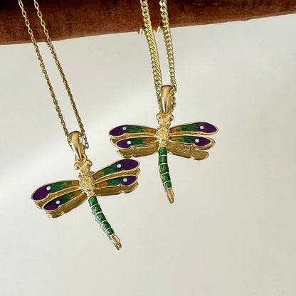 Gold dragonfly pendants with purple and green enamel, perfect for women seeking a vintage, whimsical style.