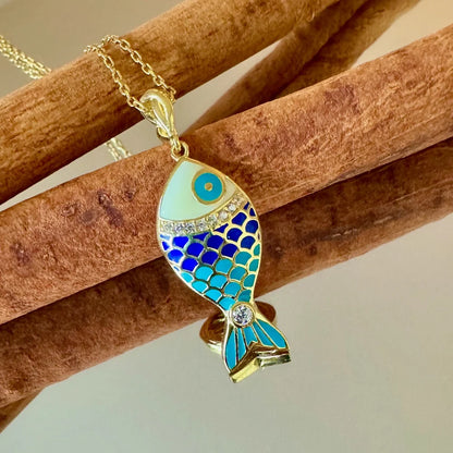 Gold fish pendant necklace with vibrant blue enamel and sparkling details, perfect for women who love whimsical jewelry.