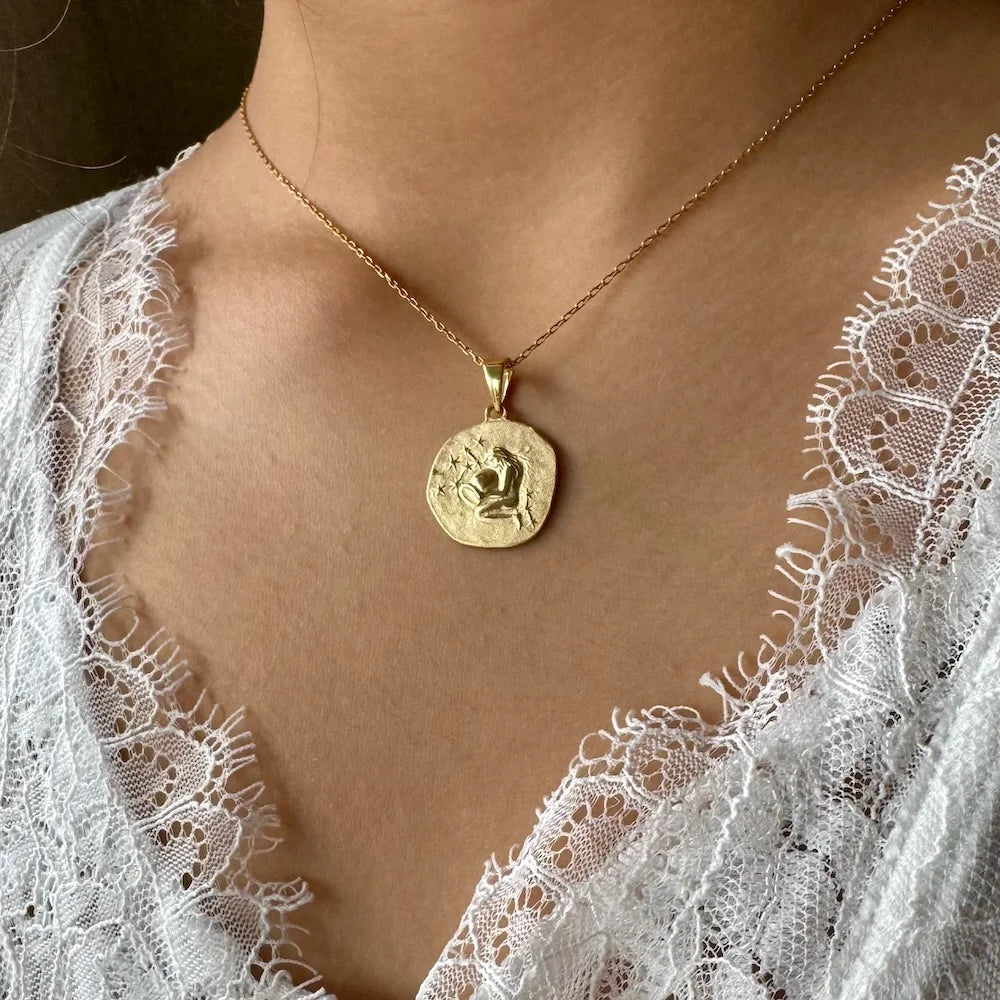 Gold pendant necklace featuring an intricate design, perfect for women seeking vintage, elegant jewelry.