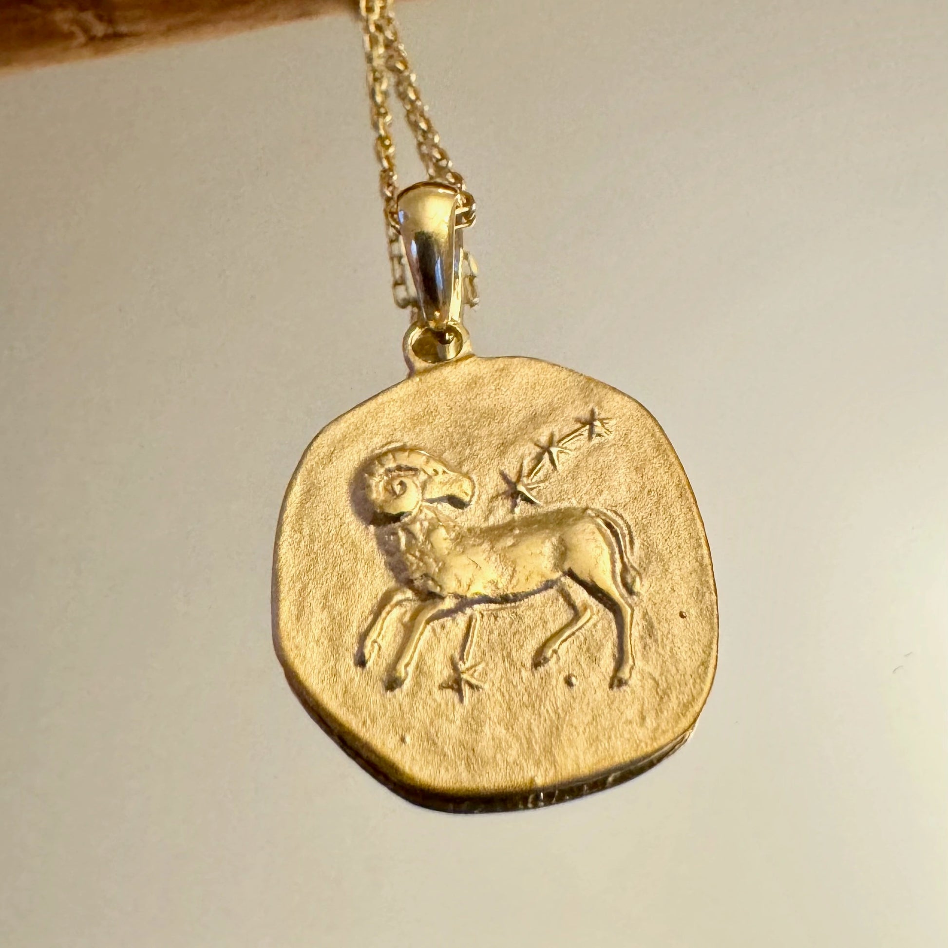 Gold Aries zodiac pendant necklace, perfect for women who love unique, vintage-inspired jewelry. Ideal for everyday wear.