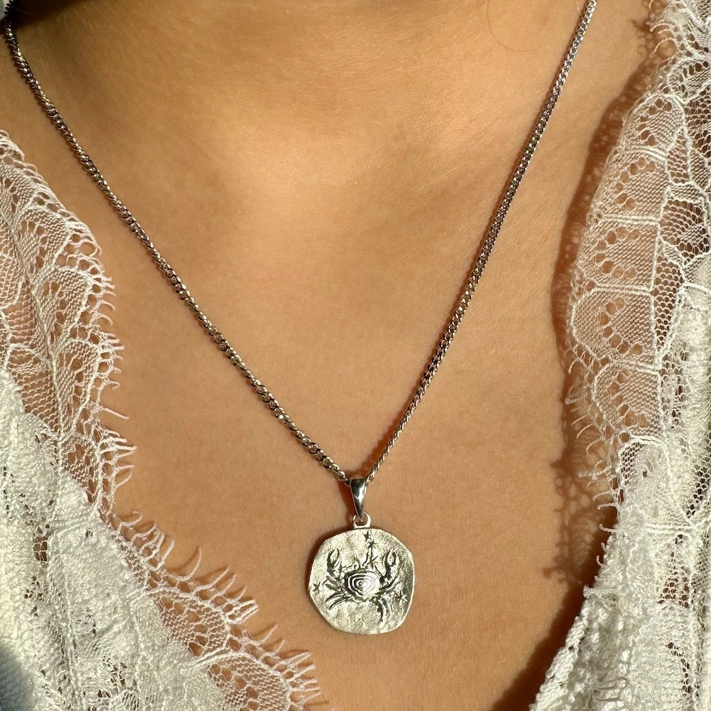 Sterling silver crab pendant necklace, perfect for women seeking unique, coastal-inspired jewelry for casual or beach occasions.