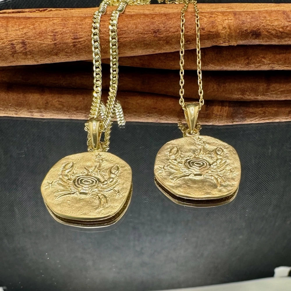 Gold crab pendant necklaces on elegant chains, perfect for women who love unique nautical-inspired jewelry.
