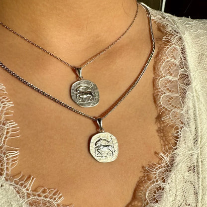 Stylish silver zodiac charm necklaces, perfect for women who love unique, bohemian jewelry for everyday wear.