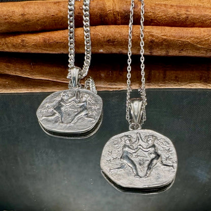 Silver pendant necklace featuring unique figural designs, ideal for unisex styling and casual or formal occasions.
