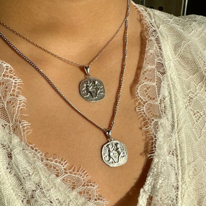 Silver pendant necklaces with intricately designed charms, perfect for women seeking minimalist, bohemian style accessories.