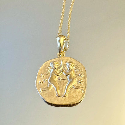 Gold Gemini zodiac pendant necklace with intricate twin design, perfect for women who love minimalist astrology jewelry.