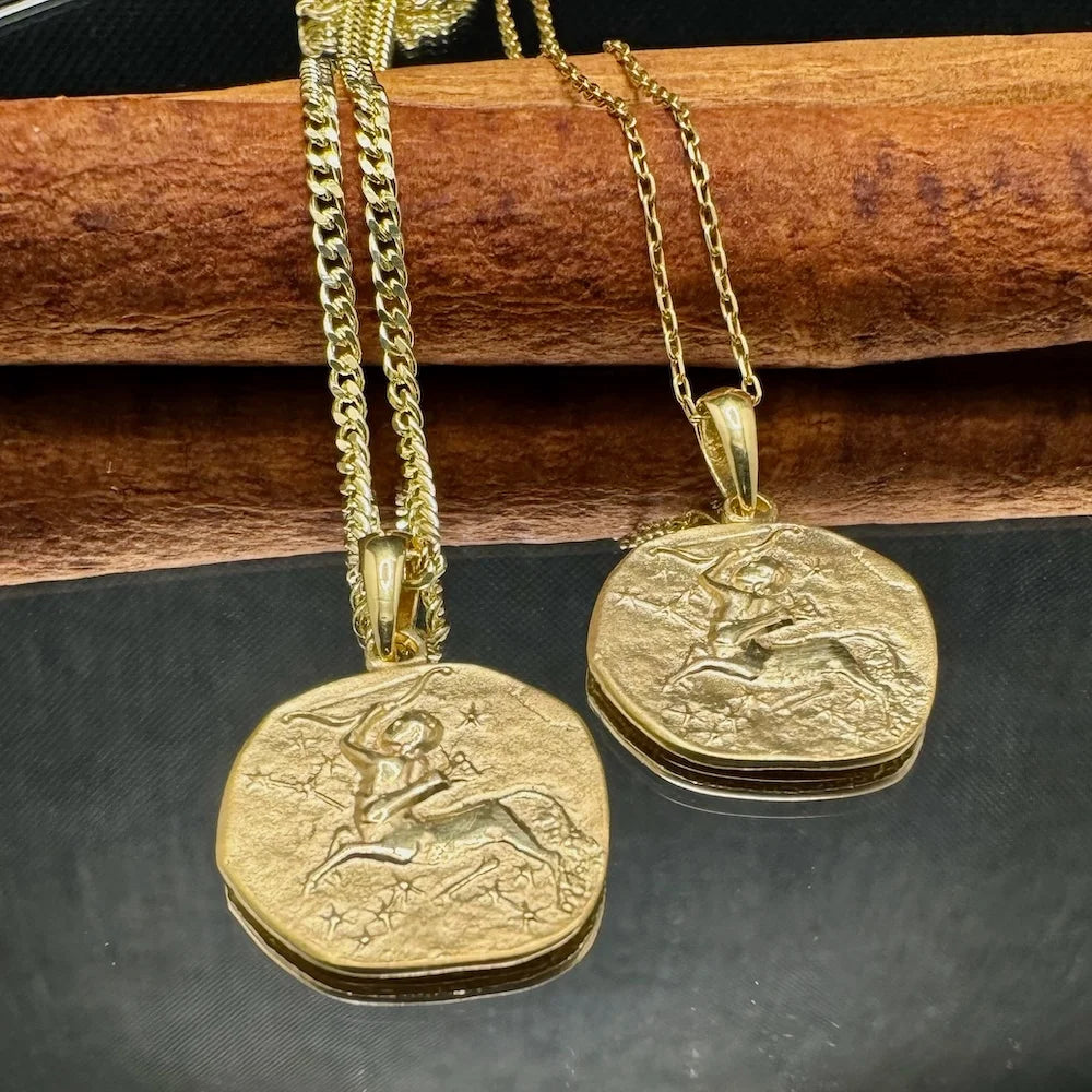 Gold pendant necklaces featuring intricate designs, perfect for unisex wear on casual or formal occasions.