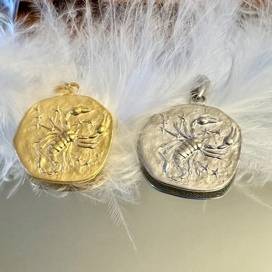 Gold and silver scorpion pendants, ideal for women who love unique, zodiac-inspired jewelry. Perfect for any occasion.