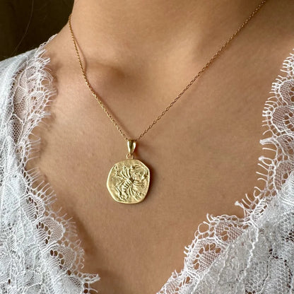 Gold vintage pendant necklace on a delicate chain, perfect for women seeking a unique, elegant accessory.