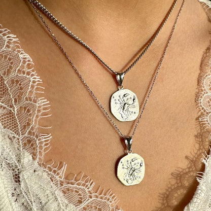 Sterling silver zodiac pendant necklace set, perfect for women who love minimalist astrology jewelry.