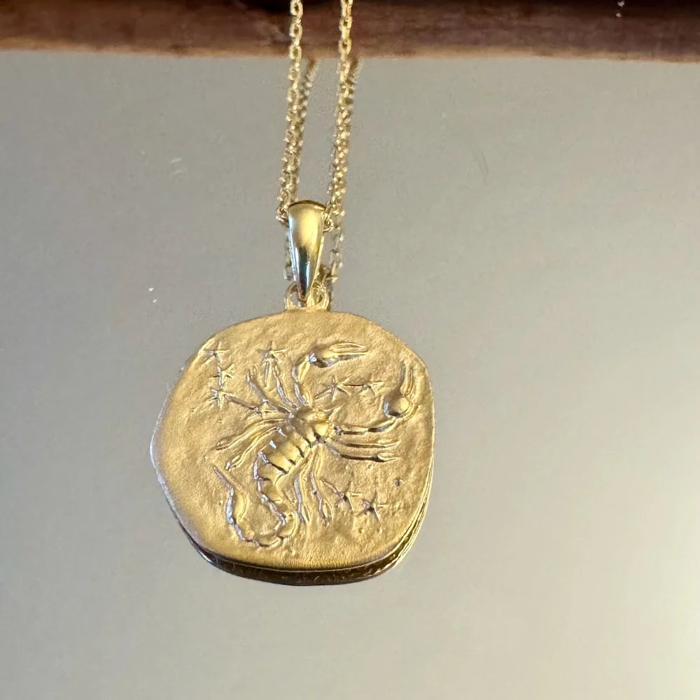 Gold Scorpio pendant necklace featuring intricate detailing, ideal for astrology lovers seeking a bohemian style.