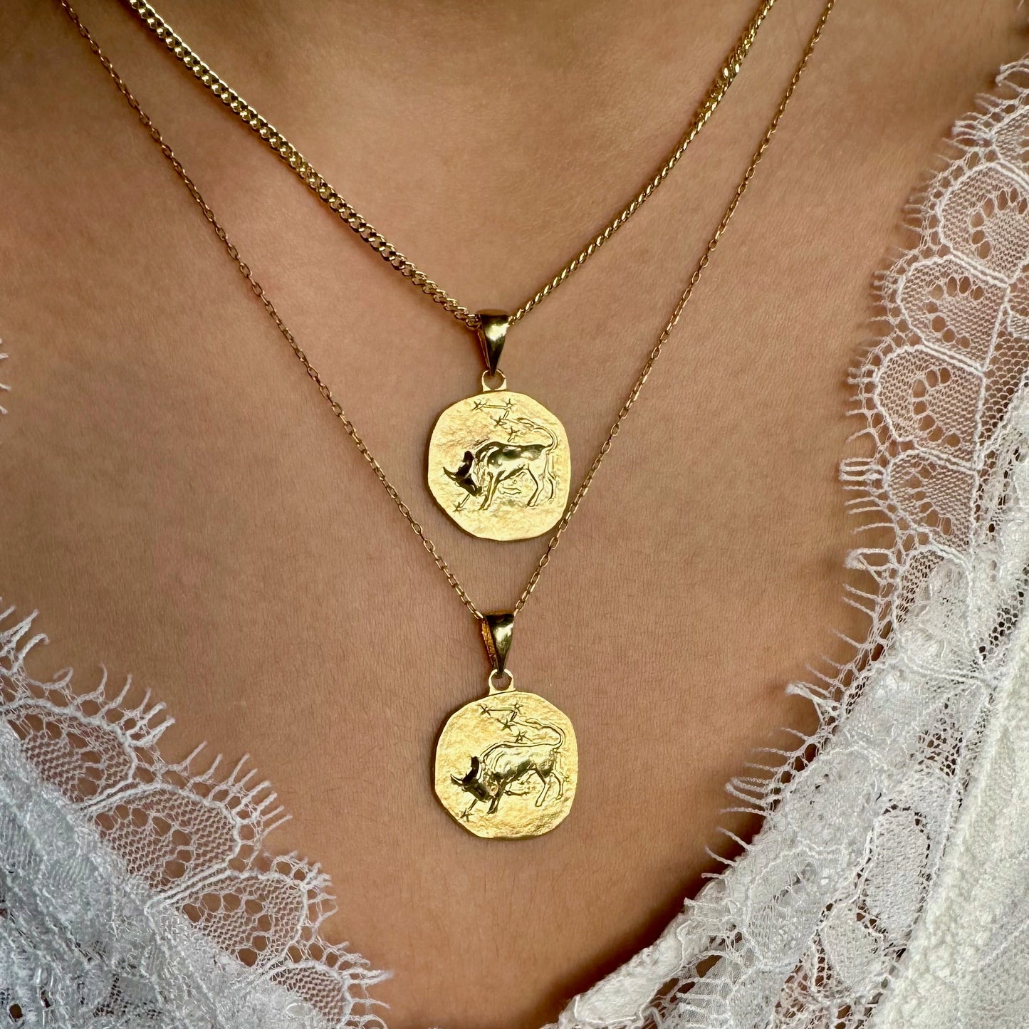 Gold layered coin necklaces featuring intricate animal designs, perfect for women seeking a vintage-inspired look.