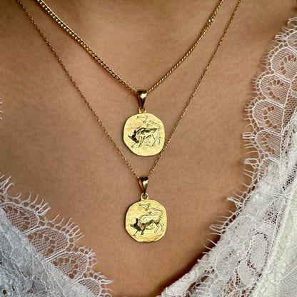 Gold layered coin necklaces featuring intricate animal designs, perfect for women seeking a vintage-inspired look.