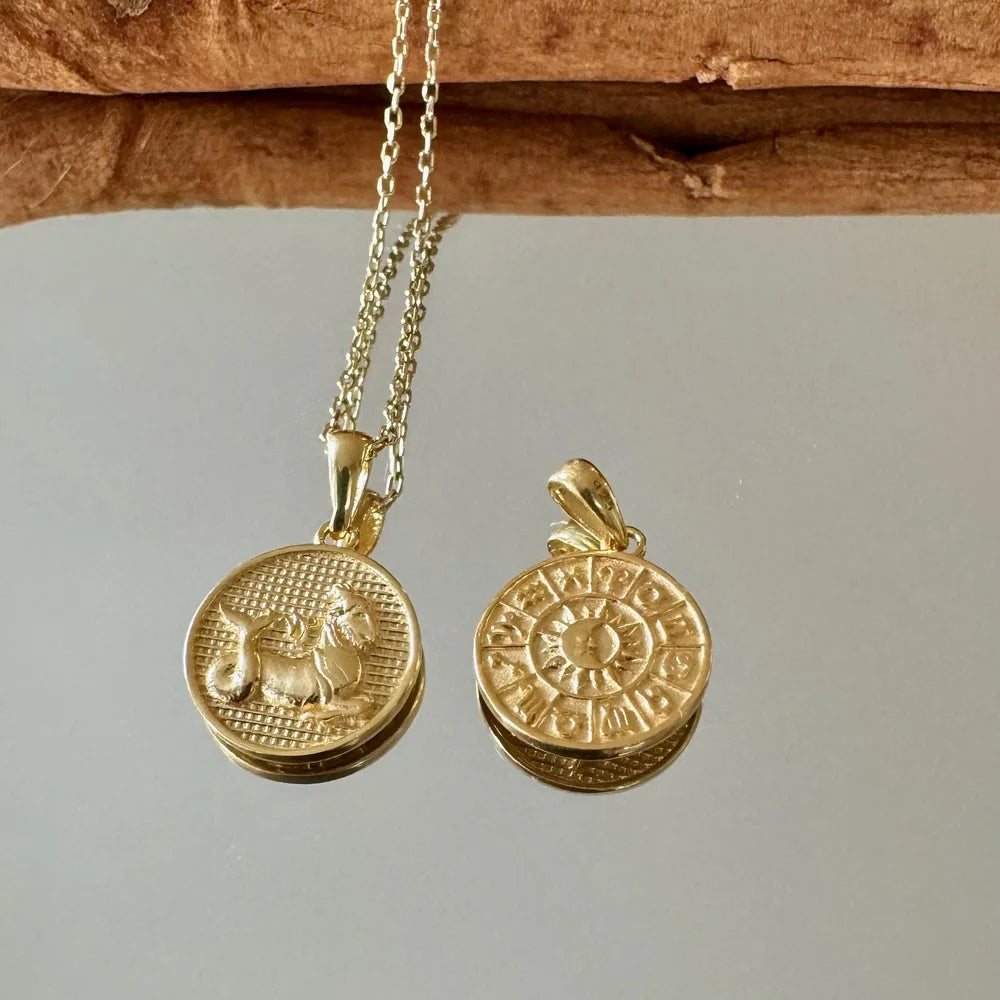 Gold vintage-inspired pendants featuring intricate designs, perfect for women seeking unique jewelry pieces.