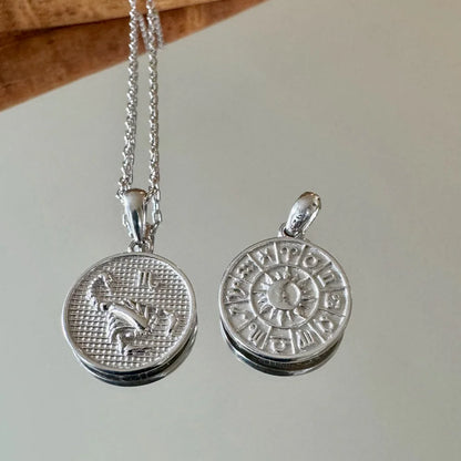 Silver zodiac pendant necklace featuring intricate astrological designs, perfect for women who love bohemian style.