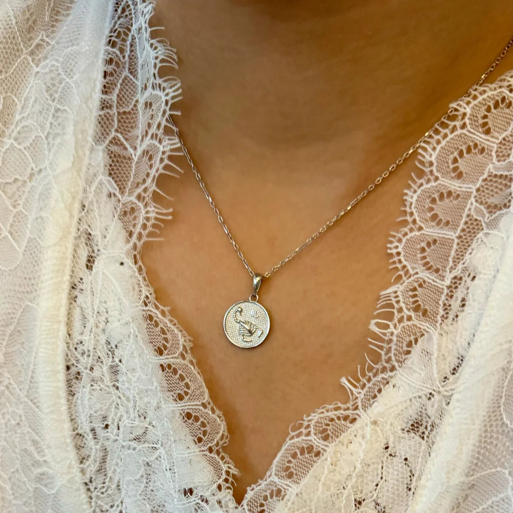 Silver pendant necklace with delicate floral design, perfect for women seeking a classic yet modern accessory.