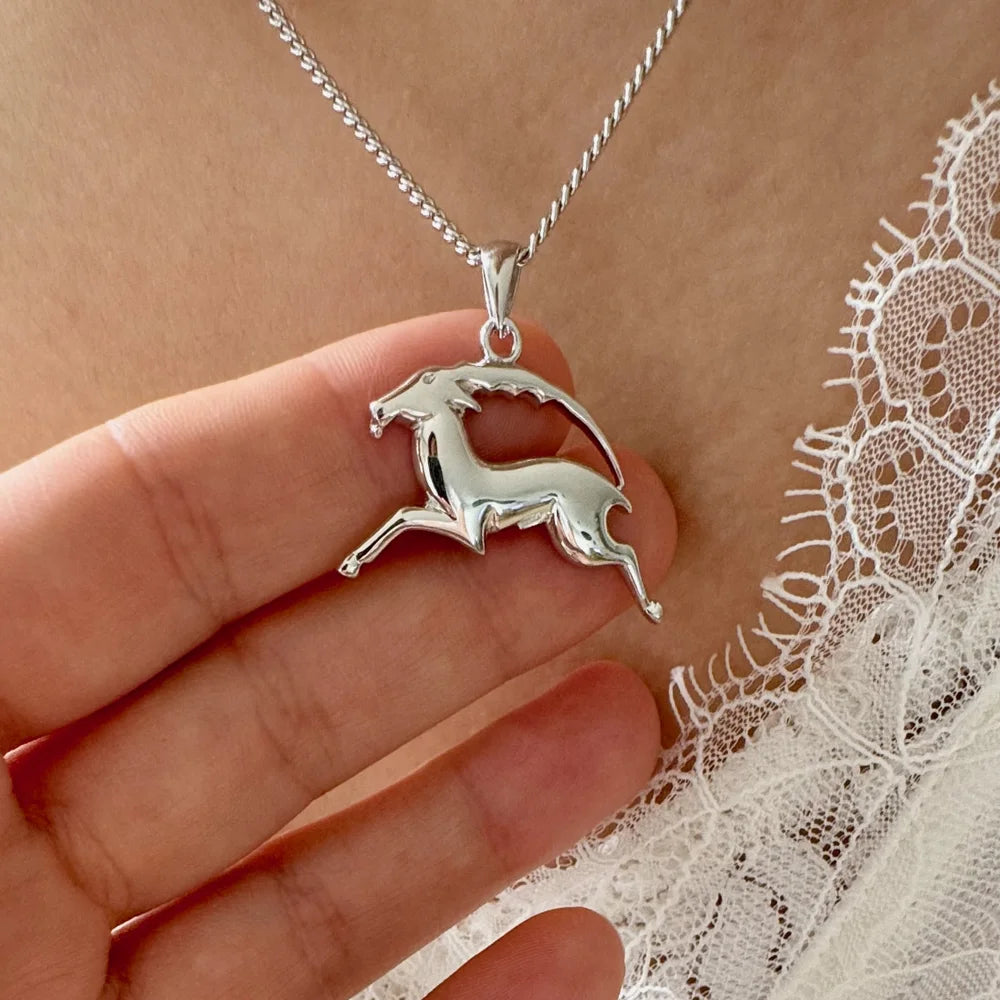 Sterling silver galloping unicorn pendant necklace, perfect for women who love whimsical, minimalist jewelry.