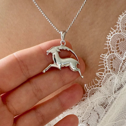 Sterling silver galloping unicorn pendant necklace, perfect for women who love whimsical, minimalist jewelry.