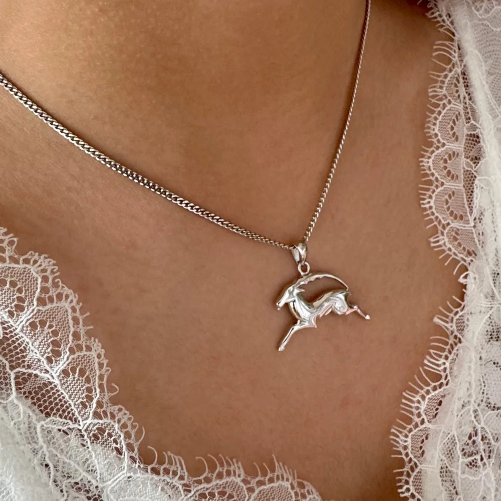 Silver unicorn pendant necklace on a delicate chain, perfect for women seeking whimsical bohemian style.