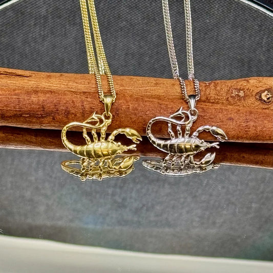 Gold and silver scorpion pendants on sleek chains, perfect for unisex wearers seeking a unique, trendy style.