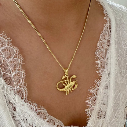 Gold scorpion pendant necklace on a delicate chain, perfect for women seeking unique bohemian style jewelry.